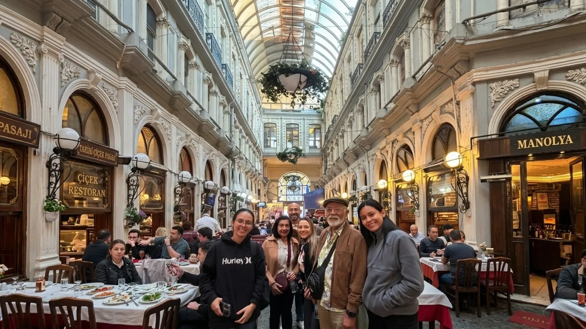 Group of tourists visiting the historic Cicek Pasaji meyhane district during a guided night tour Istanbul, showcasing the stunning 19th-century architecture and dining scene.
