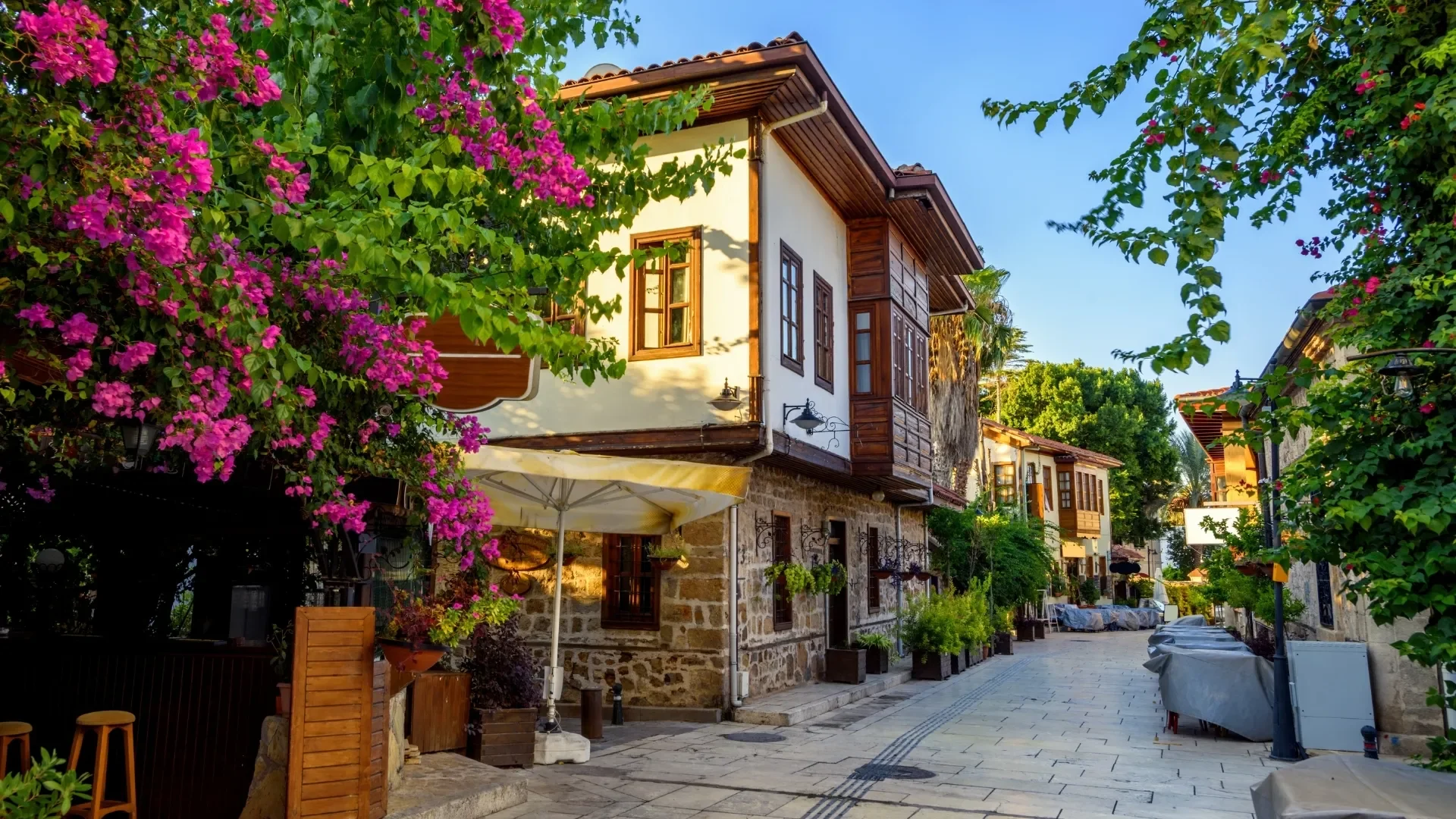Traditional Ottoman houses and colorful bougainvillea along the peaceful streets of Antalya Old Town, also known as Kaleici.