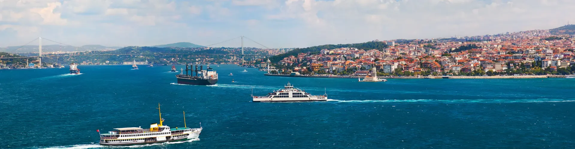 Traditional passenger ferries sailing on the scenic Bosphorus strait in Istanbul