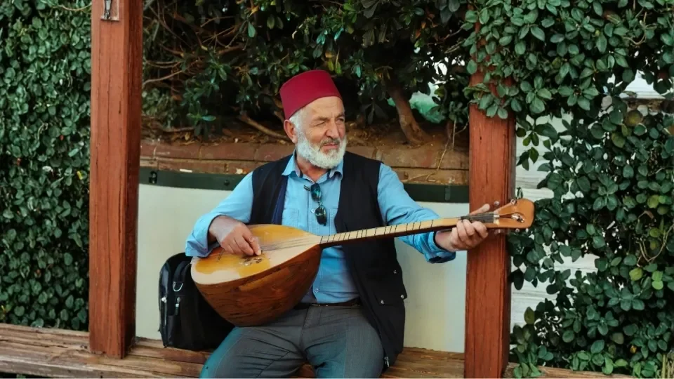 Old Turkish Man with Turkish Fez playing Baglama