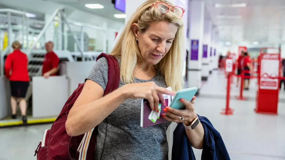 Traveler in airport with phone